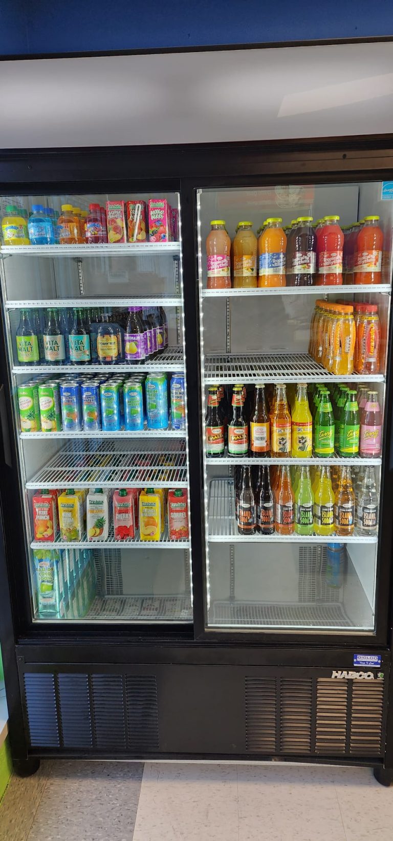 Close up shot of drinks on the fridge of Sunshine Grocers West Indian Store